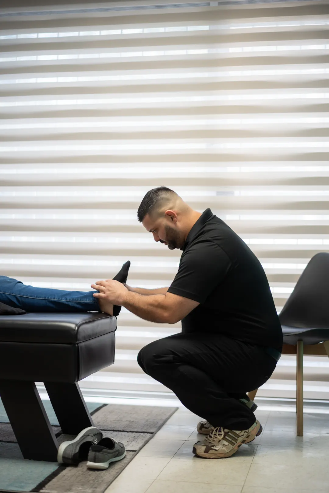Dr. Carlos performing leg treatment